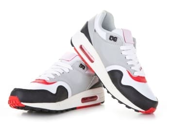 Pair of modern athletic running shoes displayed from multiple angles featuring white, gray, black, and red color scheme with visible air cushioning technology on white background
